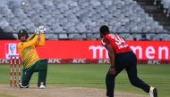 South Africa's Rassie van der Dussen (L) watches the ball after playing a shot delivered by England's Chris Jordan (R) during the third T20 international cricket match between South Africa and England at Newlands stadium in Cape Town, South Africa, on Dec