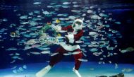 A diver wearing Santa Claus costume swims in a large fish tank during an underwater performance for the Christmas celebration, amid the coronavirus disease (COVID-19) outbreak, at Sunshine Aquarium in Tokyo, Japan, December 4, 2020. Reuters/Kim Kyung-Hoon