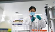 This file photo taken on September 24, 2020 shows an engineer working in the general laboratory during a media tour of a new factory built to produce a Covid-19 coronavirus vaccine at Sinovac, one of 11 Chinese companies approved to carry out clinical tri