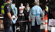 Travellers arrive at a hotel in Melbourne on December 7, 2020 where Australians returning from overseas will quarantine as part of precautions against the Covid-19 coronavirus. An outbreak of the coronavirus from hotel quarantine earlier in the year from 