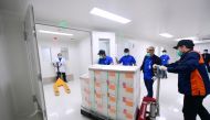 An official pushes a trolley with coronavirus disease (COVID-19) vaccines from China's Sinovac Biotech Ltd. as they arrive at PT Bio Farma (Persero) in the first shipment to Indonesia, in Bandung, West Java province, December 7, 2020. Courtesy of Muchlis 