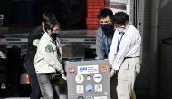 Japan Aerospace Exploration Agency's (JAXA) staff carry a case containing Hayabusa2's capsule with extensive samples of an asteroid as it arrives at JAXA Sagamihara Campus in Sagamihara in this photo taken by Kyodo December 8, 2020. Mandatory credit Kyodo