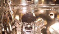 This handout photograph released by the Japan Aerospace Exploration Agency (JAXA) on December 15, 2020 shows samples of surface dust and pristine material collected from the asteroid Ryugu by the Hayabusa-2 space probe, at the JAXA Sagamihara Campus in Sa