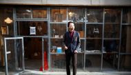Shuhei Okawara, 30, owner of mask shop Kamenya Omote, wears a face mask based on a real person's face as he stands in front of his shop in Tokyo, Japan December 16, 2020. REUTERS/Issei Kato
