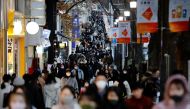 Pedestrians wearing protective masks amid the coronavirus disease (COVID-19) outbreak, make their way at a shopping district in Tokyo, Japan, December 17, 2020. (Reuters/Kim Kyung-Hoon)