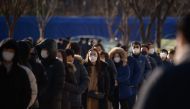 Office workers and city government employees queue at a temporary covid-19 novel coronavirus testing centre outside city hall in Seoul on December 17, 2020. / AFP / Ed JONES