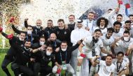 Al Sadd's coach Xavi Hernandez (centre) poses for a group picture with his players as they celebrate after Al Sadd won the Amir Cup final football match against Al Arabi on December 18, 2020. / AFP / KARIM JAAFAR