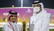 Hamad bin Abdulrahman Al Attiyah, President of Qatar and Asian Equestrian Federations, presenting the winner's trophy to team Glitter Queen's representative.