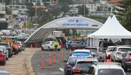 People queue in cars at a COVID-19 drive-through testing centre at Bondi Beach in Sydney on December 20, 2020. / AFP / Steven Saphore