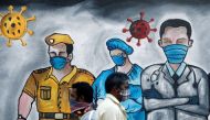 Men walk past a mural of frontline workers amid the spread of the coronavirus disease (COVID-19), in Mumbai, India, December 21, 2020. REUTERS/Francis Mascarenhas