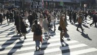 Passersby wearing protective face masks walk on the Shibuya crossing, amid the coronavirus disease (COVID-19) outbreak in Tokyo, Japan, in this photo taken by Kyodo December 26, 2020. Kyodo/via Reuters