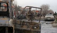 A member of Afghan security force stands guard at the site of an attack in Kabul on December 20, 2020. A car bomb targeting an Afghan lawmaker killed nine people and wounded more than a dozen in Kabul on December 20, officials said, the latest attack to r
