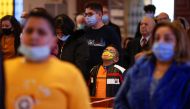 People wearing protective masks and practicing social distancing attend a Mass at Church of the Sacred Heart, as they take part in Christmas celebrations amid the coronavirus disease (COVID-19) pandemic, in Amman, Jordan, December 24, 2020. REUTERS//Muham