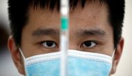 FILE PHOTO: A man works in a laboratory of Chinese vaccine maker Sinovac Biotech, developing an experimental coronavirus disease (COVID-19) vaccine, during a government-organized media tour in Beijing, China, Sept. 24, 2020. REUTERS/Thomas Peter/File Phot