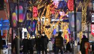 People visit a shopping district on New Year's Eve in Seoul on December 31, 2020. / AFP / Jung Yeon-je