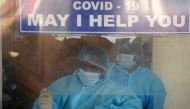 Medical staff wearing Personal protective equipment (PPE) suits work at a desk of a government hospital in Chennai on December 31, 2020. / AFP / Arun SANKAR