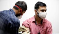 FILE PHOTO: A medic administers COVAXIN, an Indian government-backed experimental COVID-19 vaccine, to a health worker during its trials, at the Gujarat Medical Education & Research Society in Ahmedabad, India, November 26, 2020. REUTERS/Amit Dave/File Ph