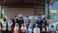 Bangladesh Ambassador to Qatar Md. Jashim Uddin (third left) with other officials and students during the book distribution ceremony.