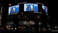 Large screens on a building show live broadcast of Japan's Prime Minister Yoshihide Suga declaring a state of emergency for Tokyo and three neighbouring prefectures in Tokyo, Japan January 7, 2021. Reuters/Issei Kato