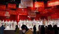 FILE PHOTO: Visitors attend an exhibition on the fight against the coronavirus disease (COVID-19) outbreak, at Wuhan Parlor Convention Center that previously served as a makeshift hospital for COVID-19 patients in Wuhan, Hubei province, China December 31,