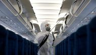 A health worker sprays disinfectant inside a Vietnam Airlines airplane to protect from the recent coronavirus outbreak, at Noi Bai airport in Hanoi, Vietnam February 21, 2020. REUTERS/Kham/File Photo