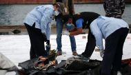 National Transportation Safety Commission (KNKT) officers inspect the debris of Sriwijaya Air flight SJ182, which crashed to the sea, at Tanjung Priok port in Jakarta, Indonesia, January 10, 2021. Reuters/Willy Kurniawan