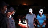 Police officers stop men wearing masks during a patrol as a nighttime curfew is reimposed amid a nationwide coronavirus disease (COVID-19) lockdown, in Pretoria, South Africa, January 9, 2021. REUTERS/Siphiwe Sibeko
