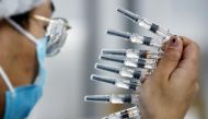 A worker performs a quality check in the packaging facility of Chinese vaccine maker Sinovac Biotech, developing an experimental coronavirus disease (COVID-19) vaccine, during a government-organized media tour in Beijing, China, September 24, 2020. REUTER