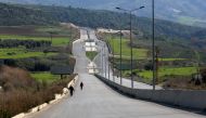 People walk along an empty road during a curfew to stem the rise in coronavirus disease (COVID-19) infections, in Nabatieh area, southern Lebanon January 10, 2021. REUTERS/Aziz Taher