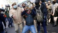 Police officers detain an activist of the youth wing of India's main opposition Congress party during a protest against new farm laws in New Delhi, India January 12, 2021. REUTERS/Adnan Abidi