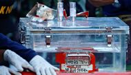 A National Transportation Safety Committee (KNKT) official holds a part of the retrieved black box of Sriwijaya Air flight SJ 182, which crashed into the sea at the weekend off the Jakarta coast, in Jakarta, Indonesia, January 12, 2021. REUTERS/Ajeng Dina
