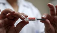 FILE PHOTO: A nurse holds a dose of China's CoronaVac, a potential vaccine against the coronavirus disease (COVID-19) before administering it to a volunteer at Emilio Ribas Institute in Sao Paulo, Brazil July 30, 2020. Picture taken July 30, 2020. REUTERS