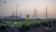 Farmers walk outside their tents at the site of a protest against new farm laws, at the Delhi-Uttar Pradesh border in Ghaziabad, India, January 11, 2021. REUTERS/Danish Siddiqui