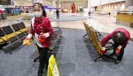 Staff members, wearing protective masks amid the coronavirus disease (Covid-19) pandemic, clean at the Taiwan Taoyuan International Airport in Taoyuan, Taiwan, January 7, 2021. Reuters/Ann Wang