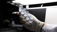 An employee inspects vials containing CoronaVac, Sinovac Biotech's vaccine against the coronavirus disease (COVID-19), at Butantan biomedical center in Sao Paulo, Brazil, January 12, 2021. REUTERS/Amanda Perobelli/File Photo