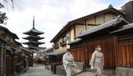 Two women walk on an unusually empty street during a state of emergency due to coronavirus disease (COVID-19) outbreak in Kyoto, Japan January 13, 2021.