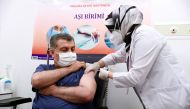 Turkish Health Minister Fahrettin Koca receives a shot of the Sinovac's CoronaVac coronavirus disease (COVID-19) vaccine at Ankara City Hospital?in Ankara, Turkey, January 13, 2021. Turkish Health Ministry/Handout via REUTERS