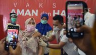 A doctor receives a dose of the Sinovac's vaccine as Indonesia begins mass vaccination for the coronavirus disease (COVID-19), at a hospital in Pekanbaru, Riau province, Indonesia, January 14, 2021 in this photo taken by Antara Foto. Antara Foto/Nova Wahy