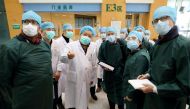 FILE PHOTO: Experts from China and the World Health Organization (WHO) joint team wearing face masks visit Wuhan Tongji Hospital in Wuhan, the epicentre of the novel coronavirus outbreak, in Hubei province, China February 23, 2020. China Daily via REUTERS