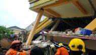 Members of a search and rescue agency team dig through rubble after an earthquake, in Mamuju, West Sulawesi Province, Indonesia January 15, 2021. Basarnas Sulbar/via REUTERS