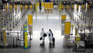 FILE PHOTO: Passengers wearing hazmat suits for protection against the coronavirus disease (COVID-19) walk inside the Ninoy Aquino International Airport in Paranaque, Metro Manila, Philippines, January 14, 2021. REUTERS/Eloisa Lopez/File Photo
