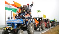 FILE PHOTO: Farmers participate in a tractor rally to protest against the newly passed farm bills, on a highway on the outskirts of New Delhi, India, January 7, 2021. REUTERS/Adnan Abidi/File Photo
