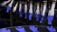 Newly-made gloves are pictured inside Top Glove factory in Shah Alam, Malaysia August 26, 2020. REUTERS/Lim Huey Teng/File Photo
