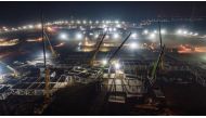 A general view shows cranes and workers at the construction site of a centralised quarantine facility at Guying village, following a recent coronavirus disease (COVID-19) outbreak in Shijiazhuang, Hebei province, China January 14, 2021. China Daily via Re