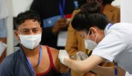 Sanitation worker Manish Kumar, who according to the officials is the first person in the country vaccinated against the Covid-19, receives a dose of Bharat Biotech's COVAXIN. Reuters/Adnan Abidi