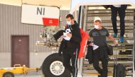 Tennis players and officials exit off flight at Melbourne Jet Base, to undergo a quarantine required of all players competing in the upcoming Australian Open, in Melbourne, Australia, January 14, 2021. AAP Image/James Ross via Reuters