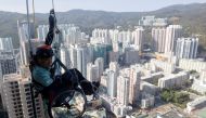 Lai Chi-wai, a paraplegic climber, attempts to climb the 320-metre tall Nina Tower using only his upper body strength, in Hong Kong, China January 16, 2021. On this attempt, Lai completed 250-meters (75/f), as he faced strong winds. Picture taken January 