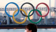 FILE PHOTO: A man wears a protective mask amid the coronavirus disease (COVID-19) outbreak in front of the giant Olympic rings in Tokyo, Japan, January 13, 2021. REUTERS/Kim Kyung-Hoon/File Photo
