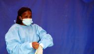 A health worker wears protective clothing as she prepares for testing travellers for the coronavirus disease amid a nationwide Covid-19 lockdown, at the Grasmere Toll Plaza, in Lenasia, South Africa, January 14, 2021. Reuters/Siphiwe Sibeko/File Photo 