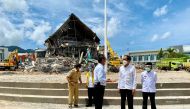Indonesian President Joko Widodo talks with an official during a visit inspecting the area affected by the earthquake in Mamuju, West Sulawesi province, Indonesia, January 19, 2021. Courtesy of Indonesia's Presidential Palace/Handout via REUTERS